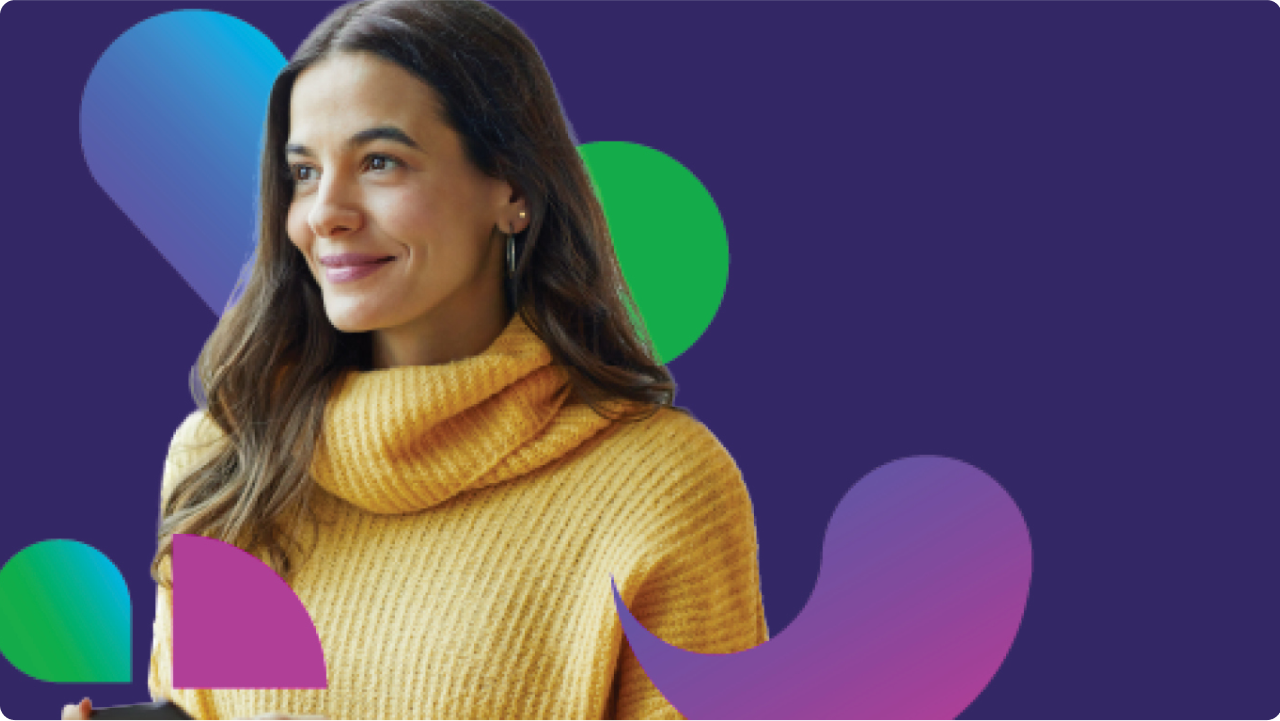 Woman smiling in gold sweater with different color pavers and purple in the background