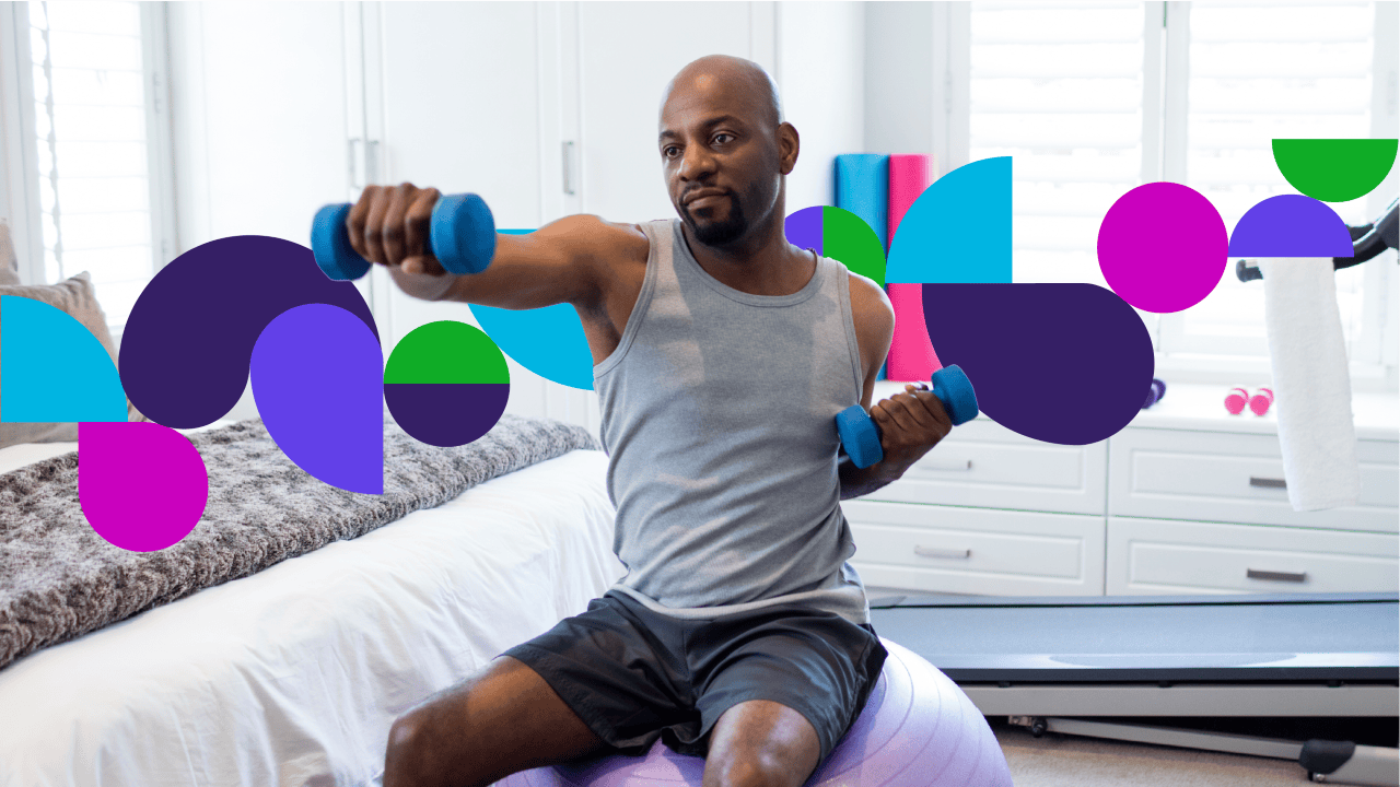 Man sitting on exercise ball doing exercise with weights