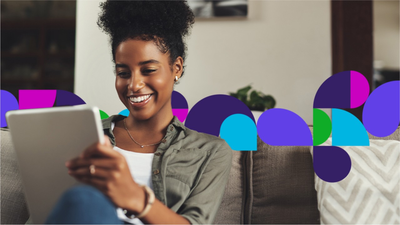Woman smiling looking at tablet