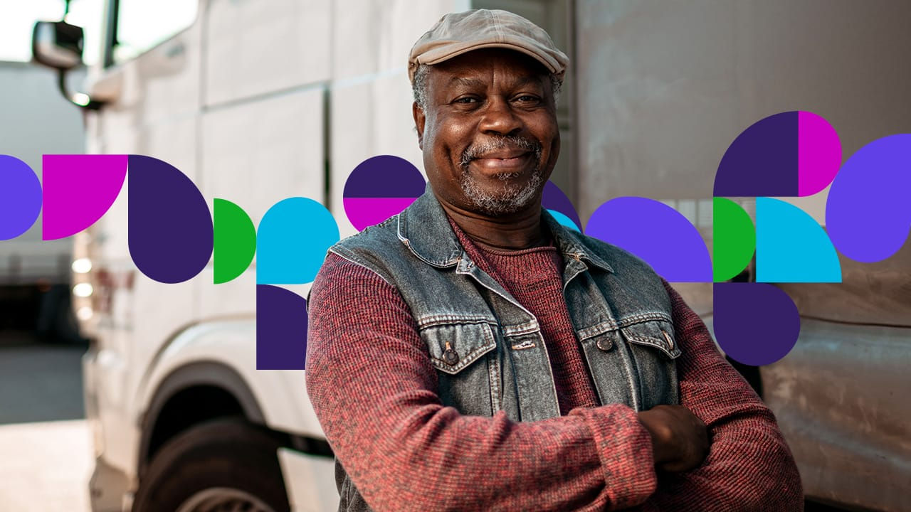 Man smiling standing next to semi truck