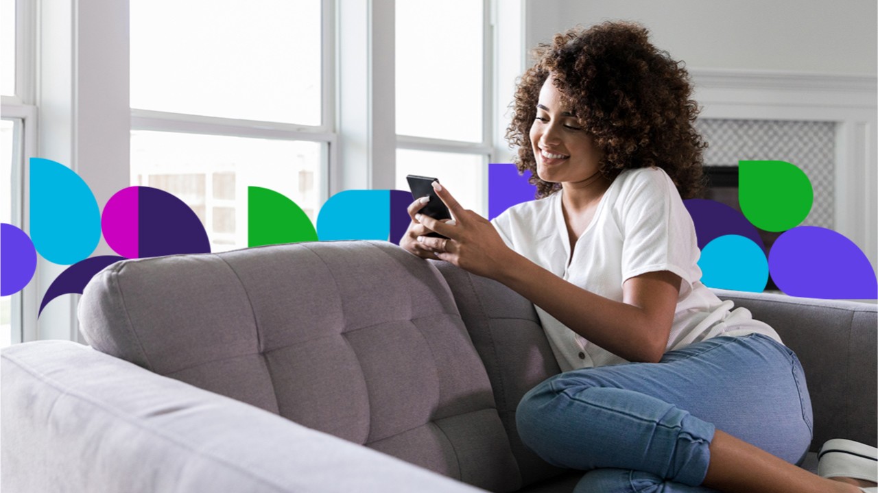 Woman on couch using cell phone