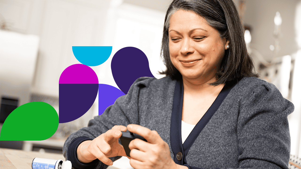 Woman smiling looking at device in hands