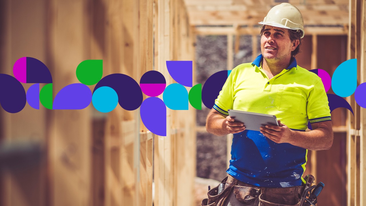 Construction worker at construction site holding tablet