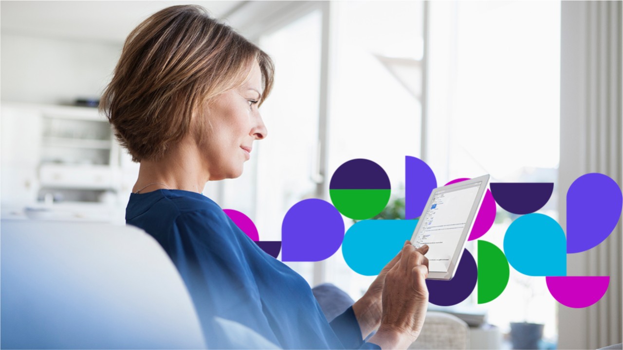 Woman sitting on couch looking at tablet