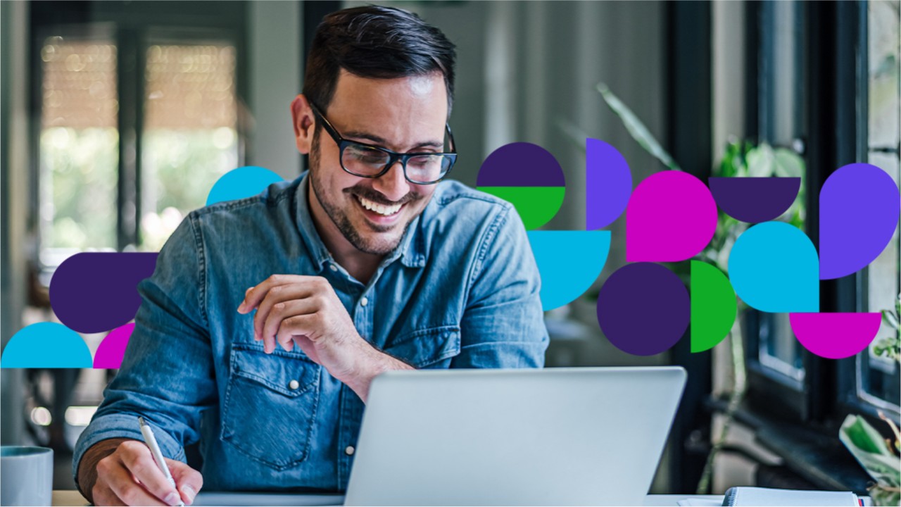 Man smiling looking at laptop