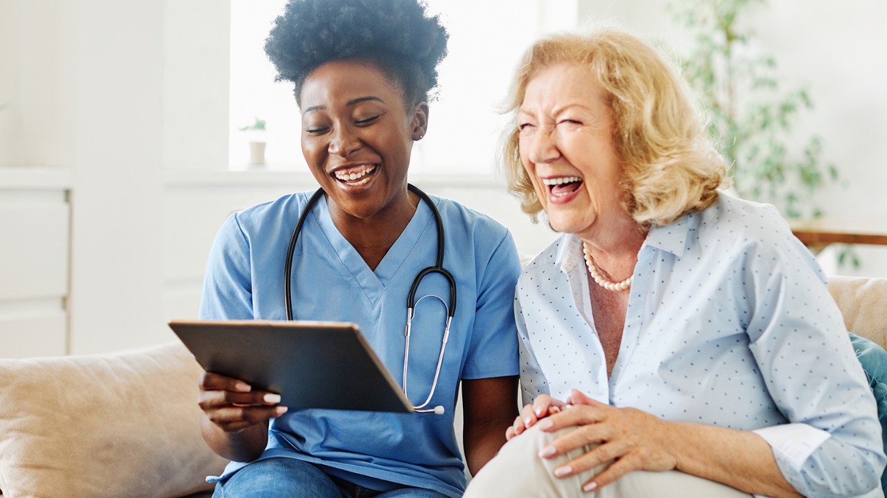Nurse and patient reviewing a medical chart on a smart device