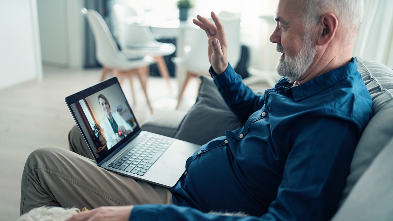Senior talking with doctor on laptop
