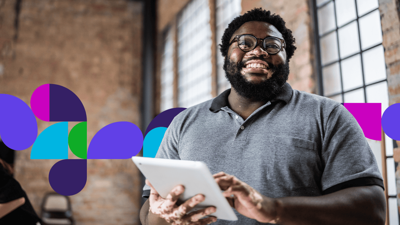 Man smiling using tablet