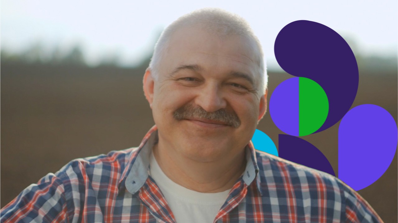 Senior man smiling standing in field