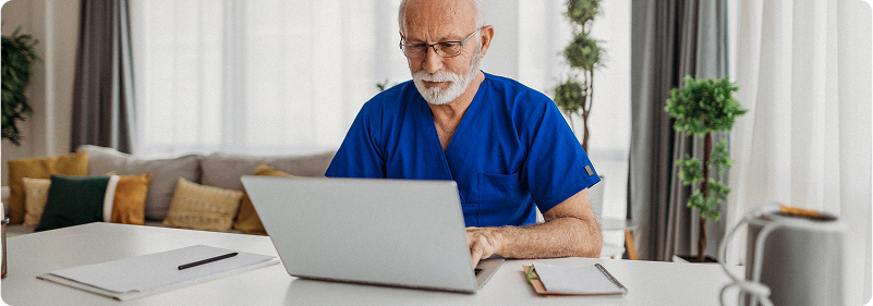 Virtual nurse interacting with a patient via video monitor in a hospital room.