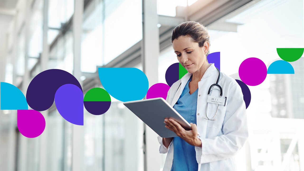 Doctor in hallway looking at tablet