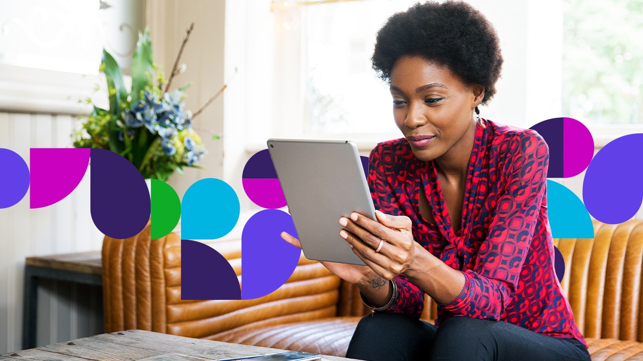  Woman sitting on couch looking at tablet