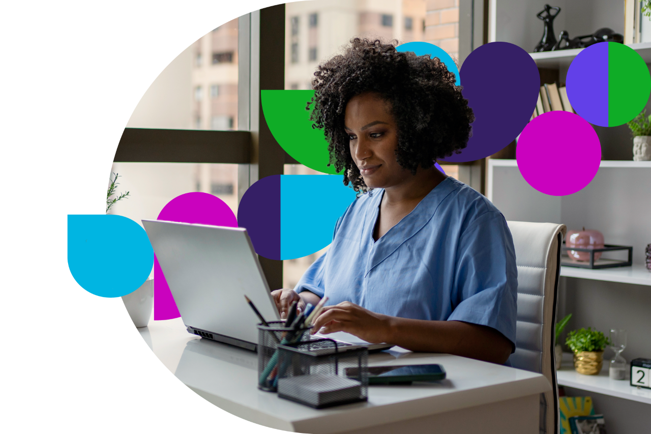 Medical professional working on laptop at desk