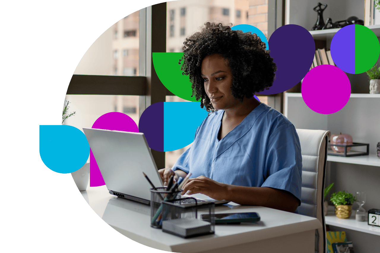 Medical professional working on laptop at desk