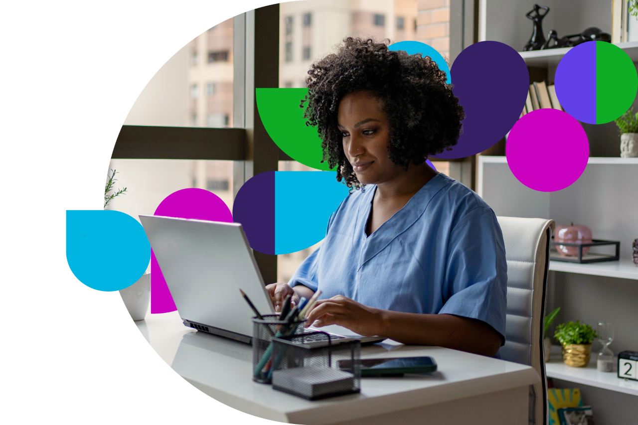Medical professional working on laptop at desk