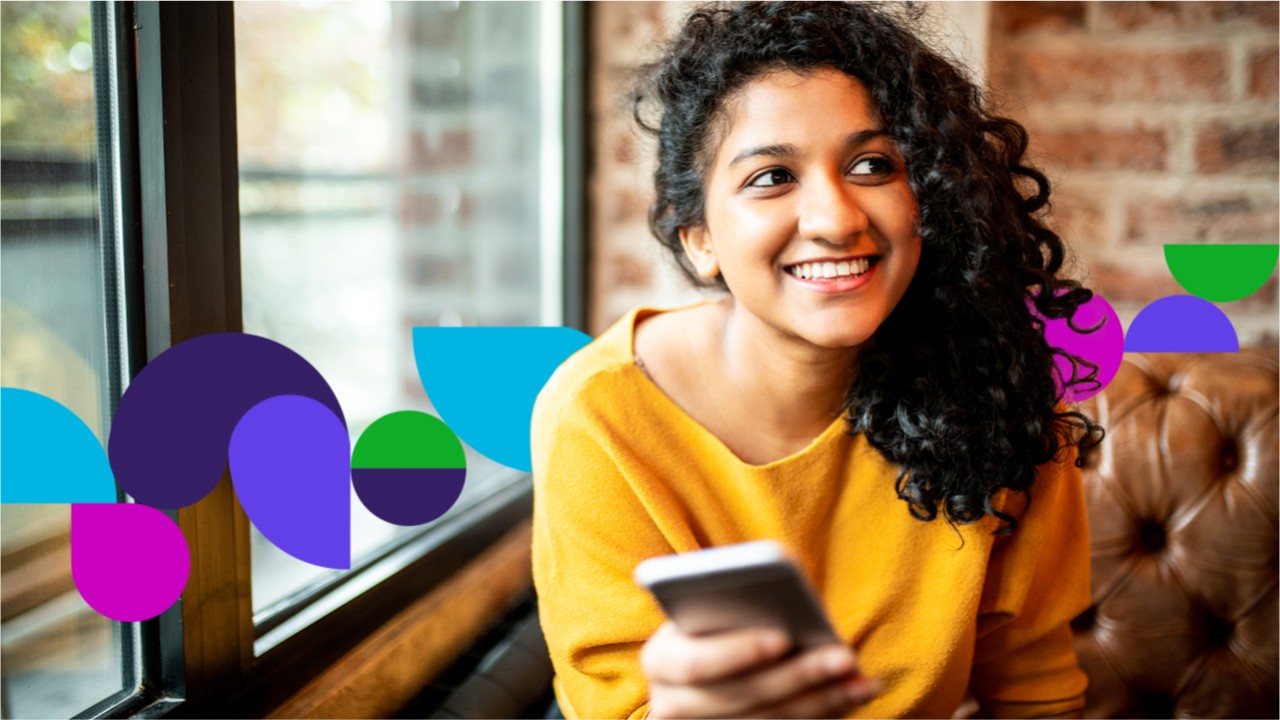 Woman smiling holding a phone