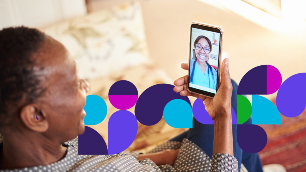 Person holding phone showing doctor on screen