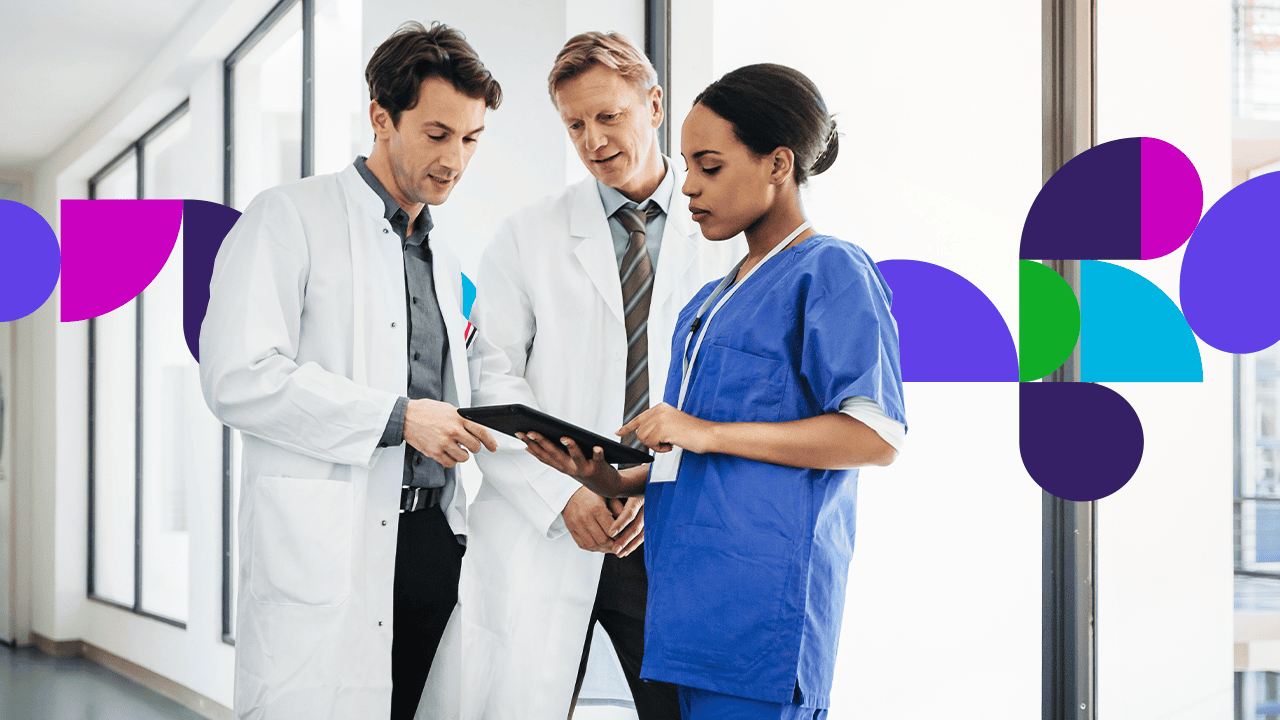 Medical professionals in hallway looking at tablet together