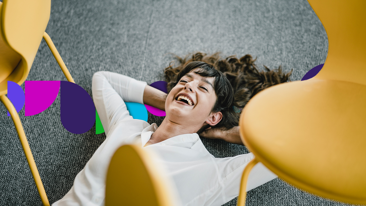 Woman lying on the floor between two chairs
