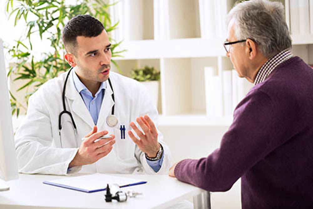 Doctor talking with old patient